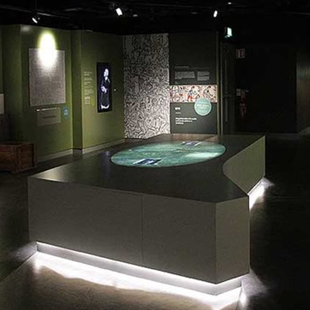 Visitors exploring medieval castle life exhibition with audio-visual displays