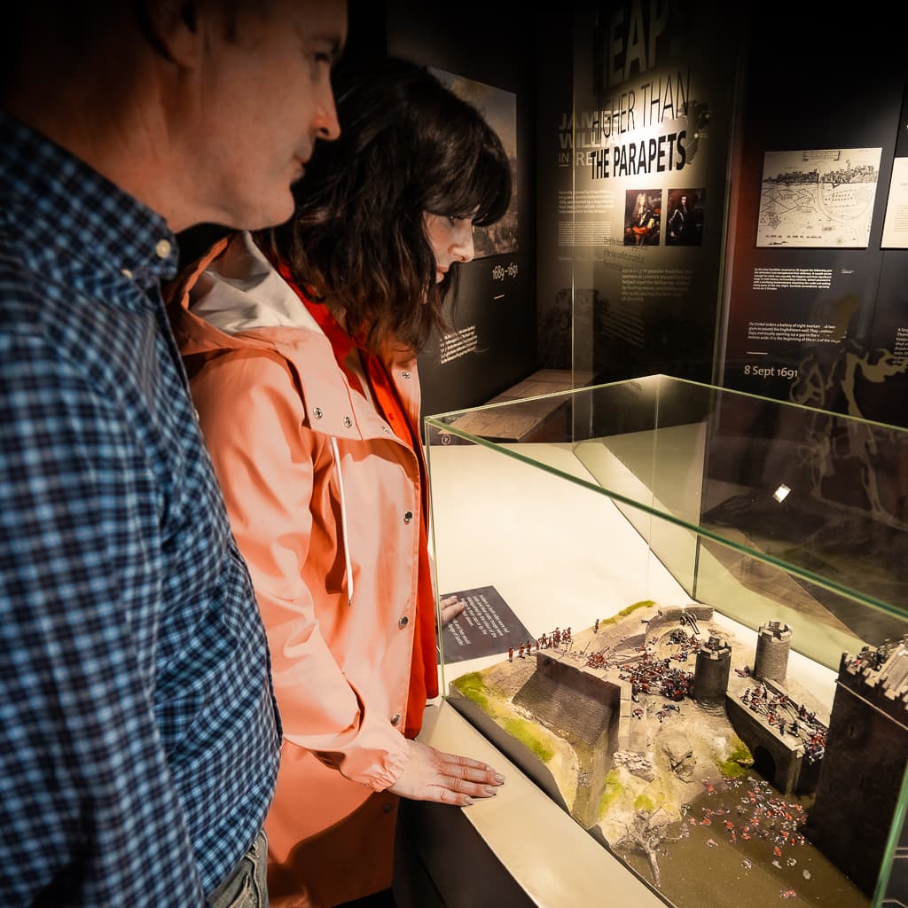 Visitors observing interactive diorama depicting historical battle scene
